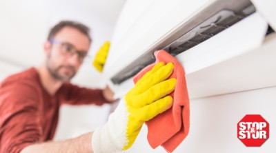 Stop and Stor employee cleaning air conditioning unit