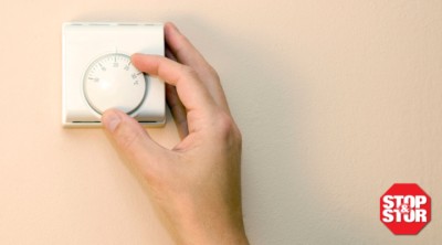 Person adjusts temperature control dial by hand