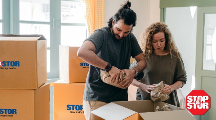 man and woman packing storage boxes