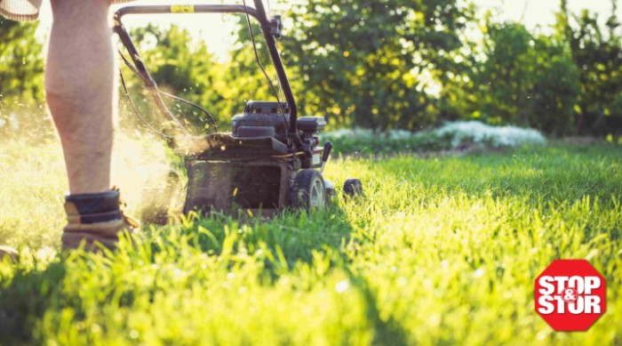 person mowing the lawn with a push mower
