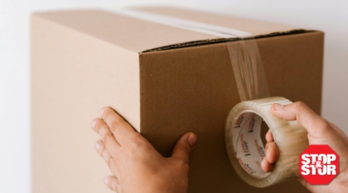 storage box being duct taped by person