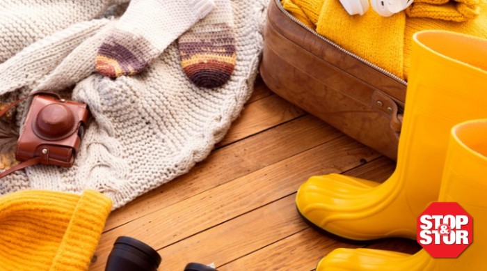 fall yellow rain boots and blankets on a wood floor