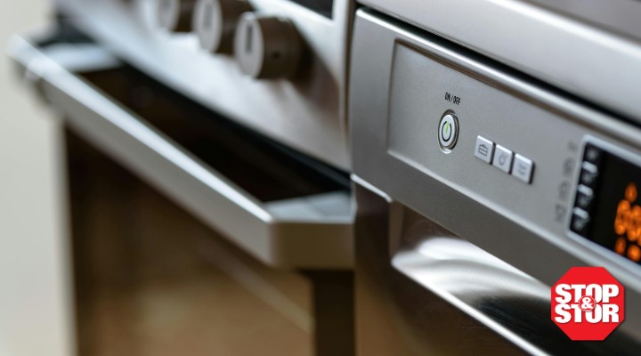 the front of an oven with buttons and dials