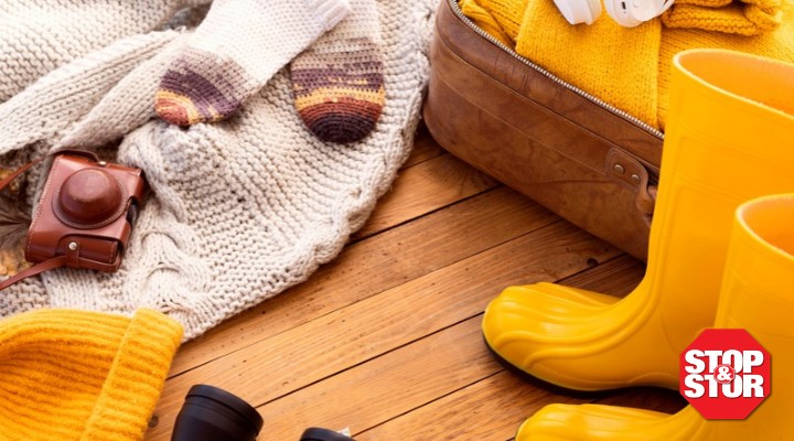 fall yellow rain boots and blankets on a wood floor